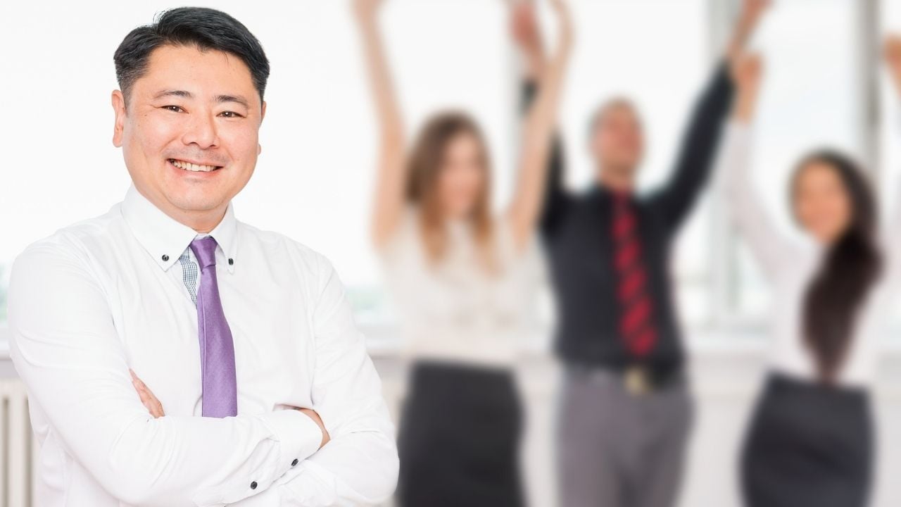 asian boss with workers in background